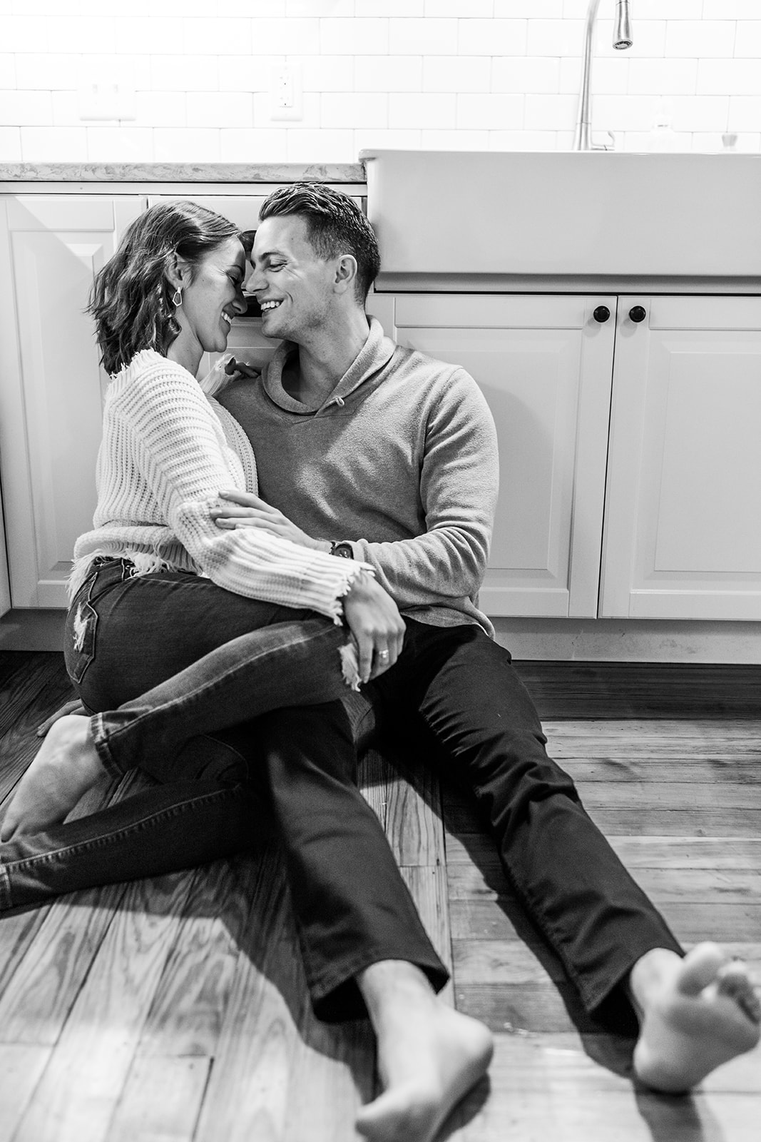 Couple engagement session at home sitting on kitchen floor