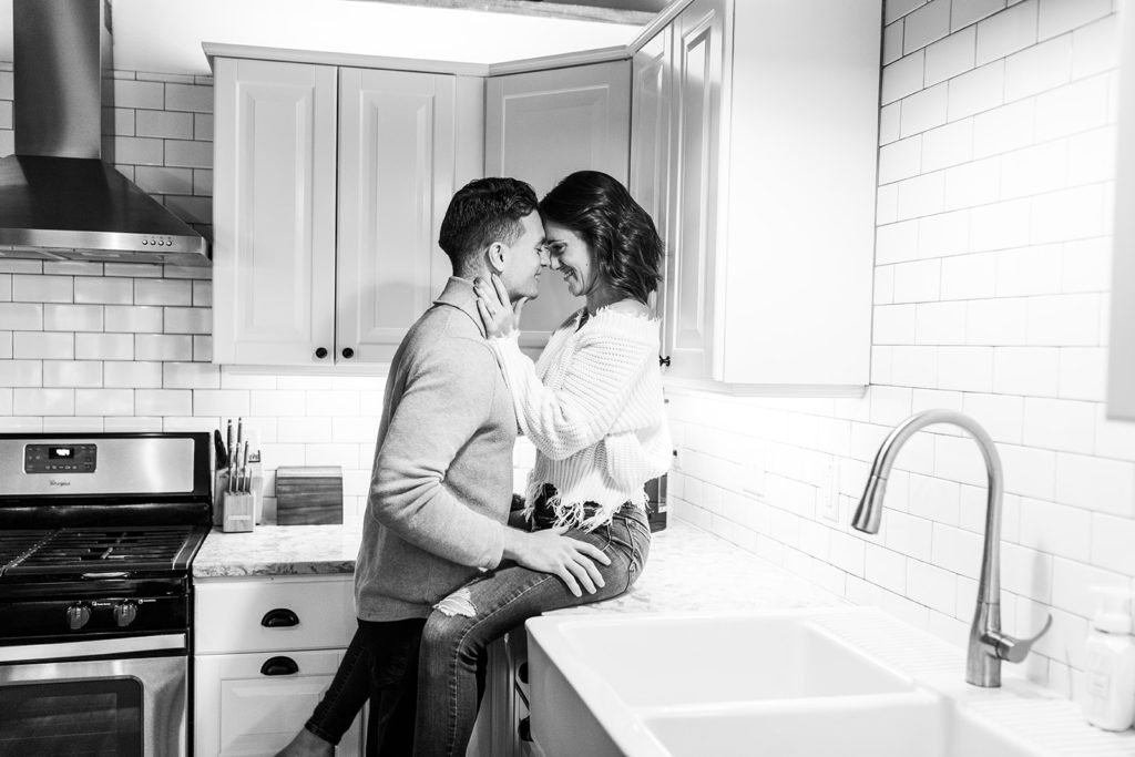 Couple engagement session sitting in kitchen counter