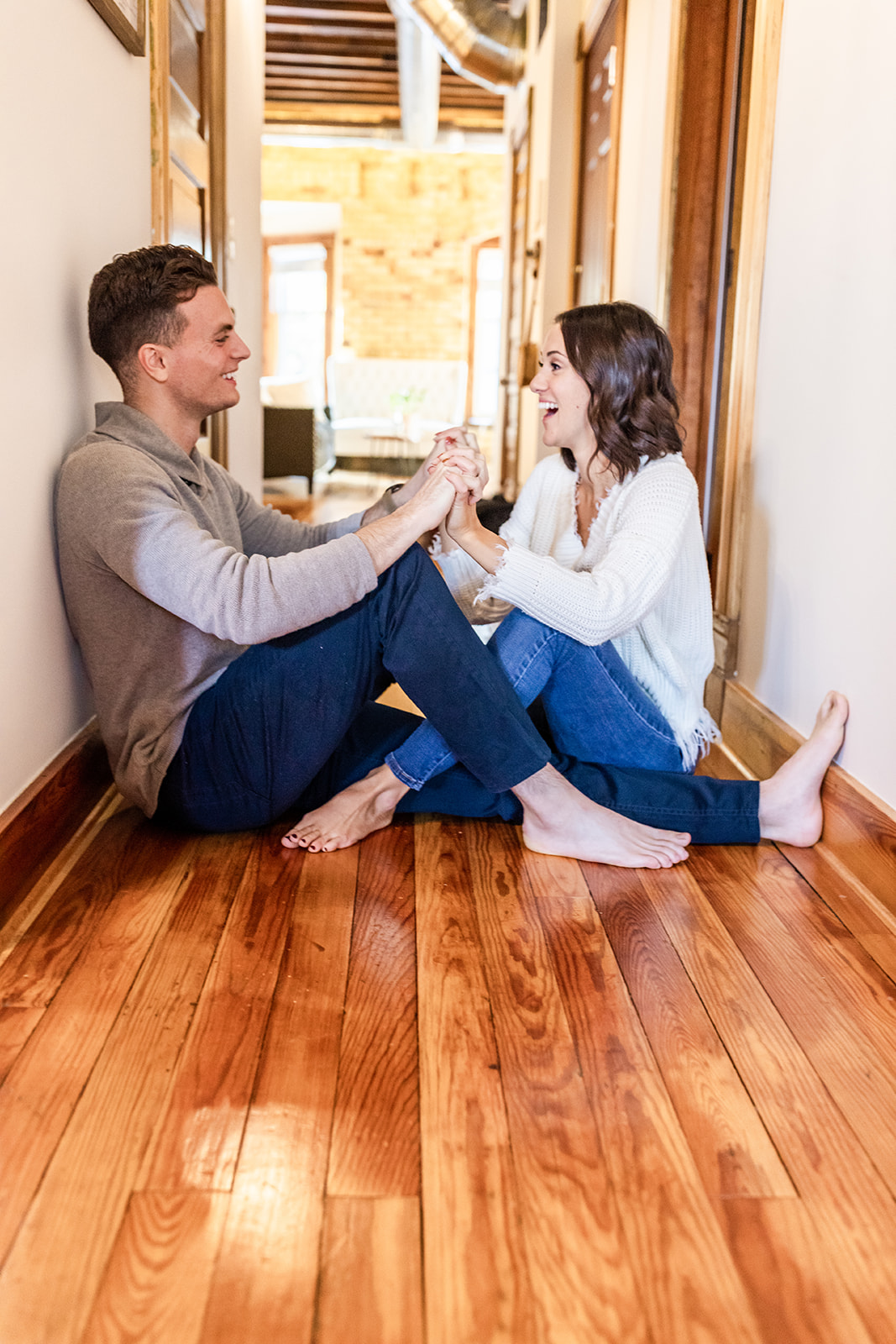 Couple engagement session at home sitting in hallway