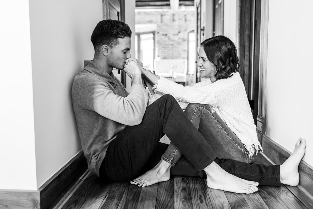 Couple engagement session at home in hallway of living room