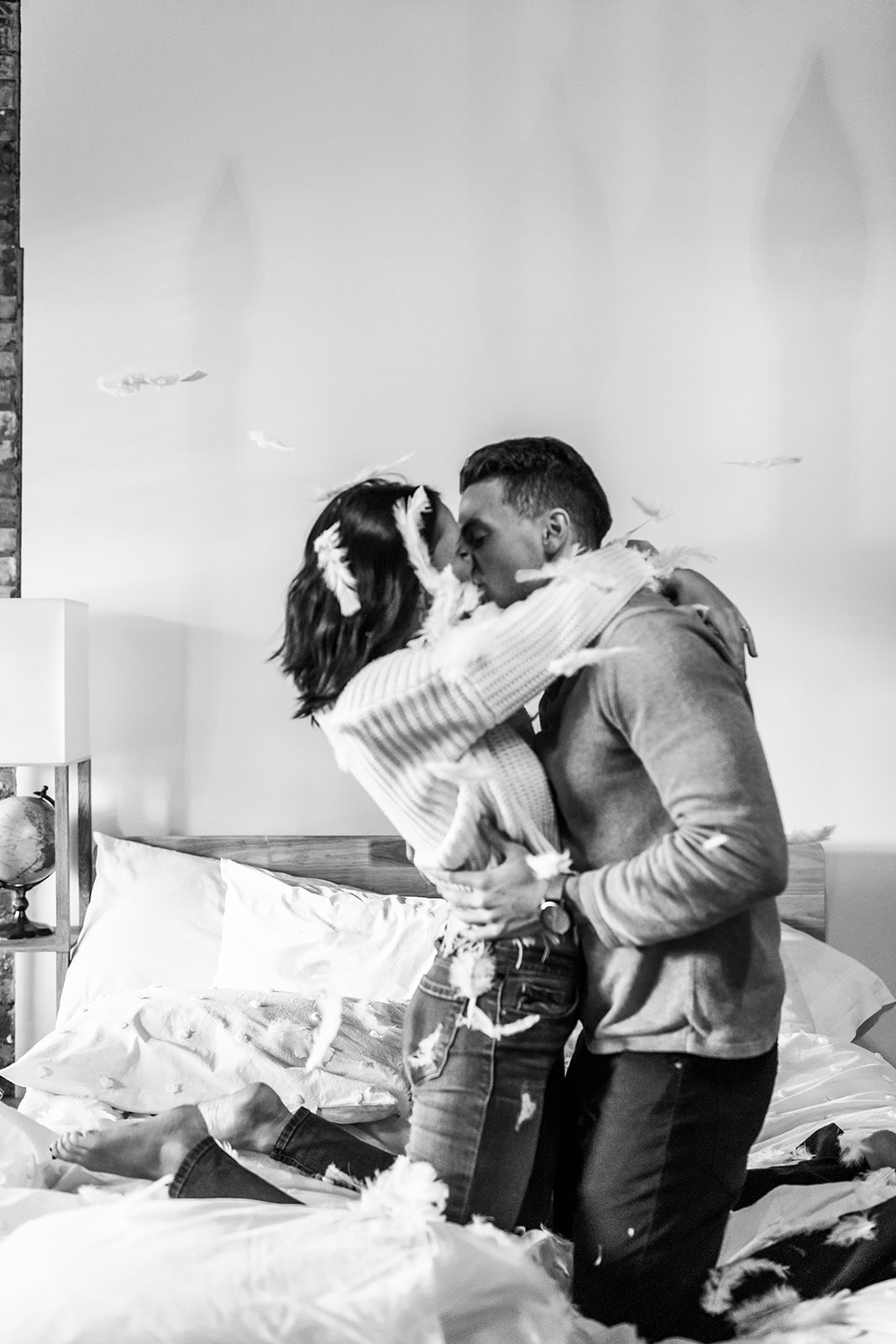 Couple pillow fight at home engagement photos in Michigan