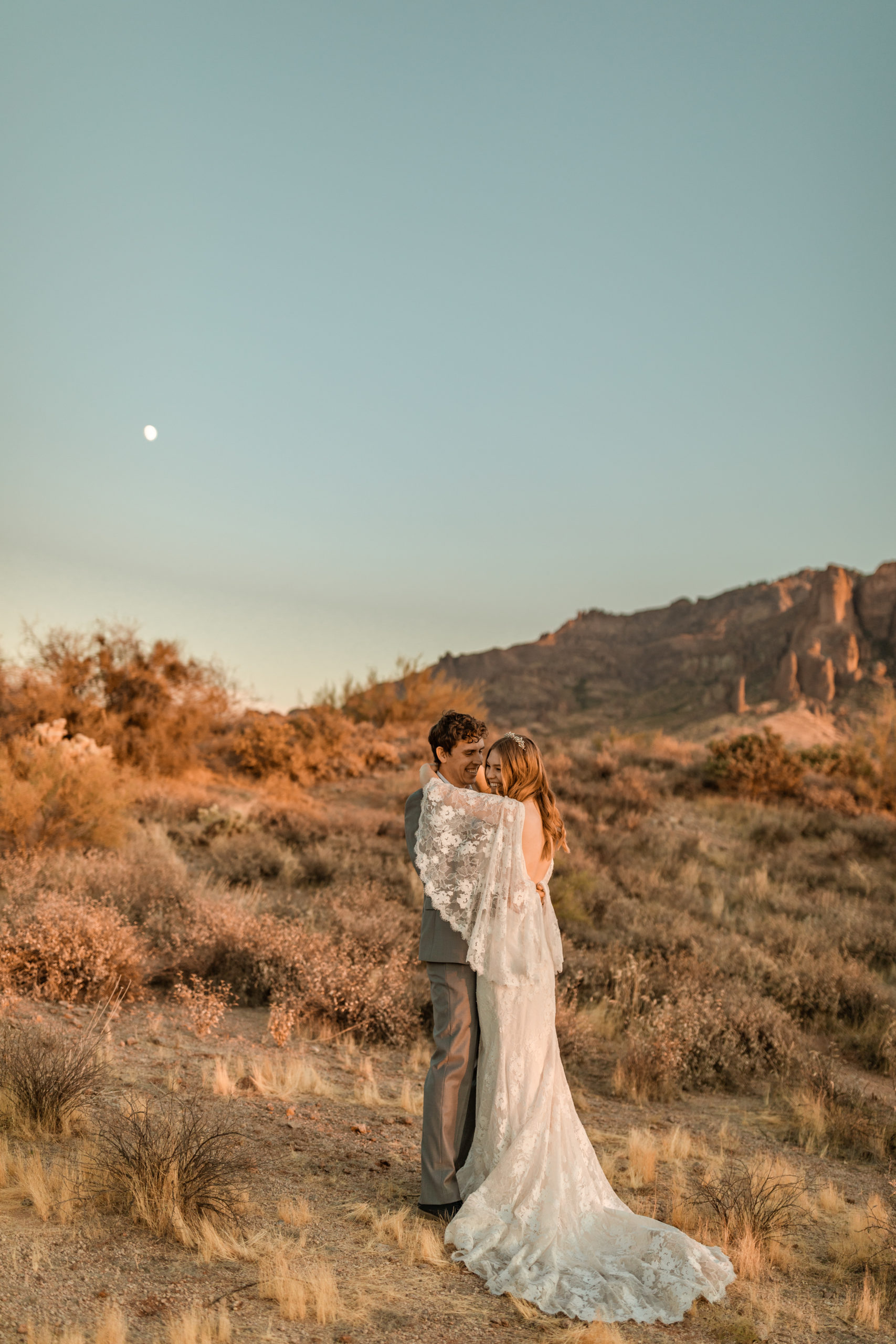 bride and groom hugging at Arizona elopement during sunset
