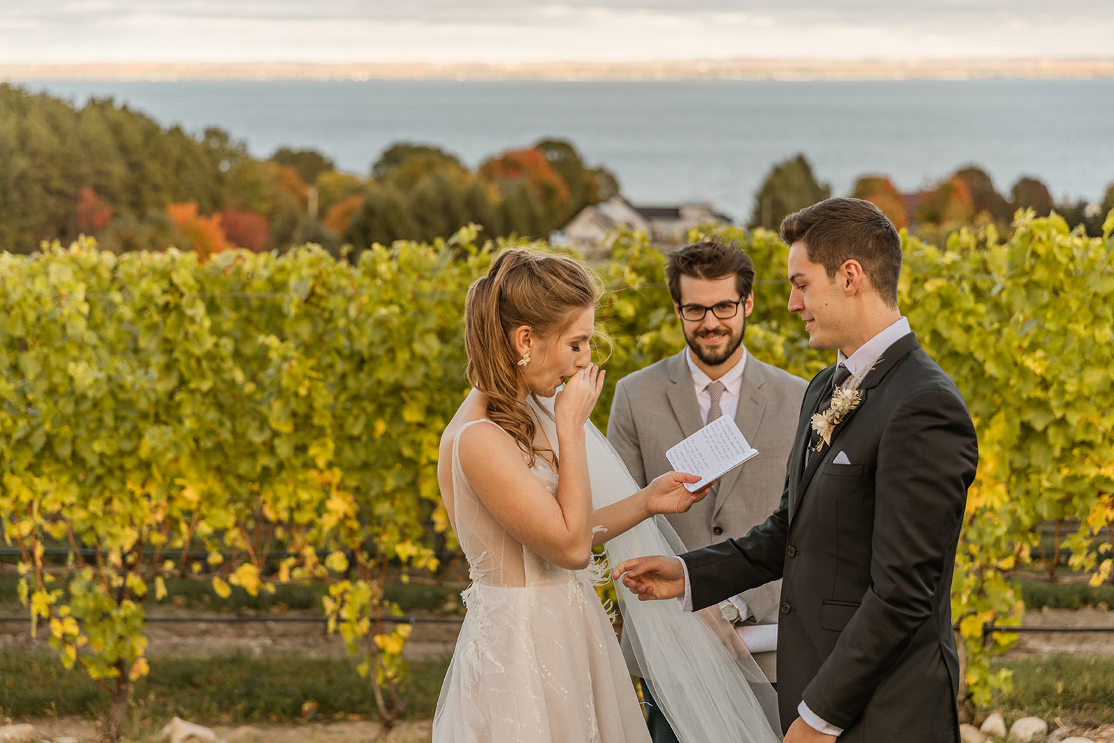 bride crying in elopement ceremony sharing vows in Northern Michigan winery