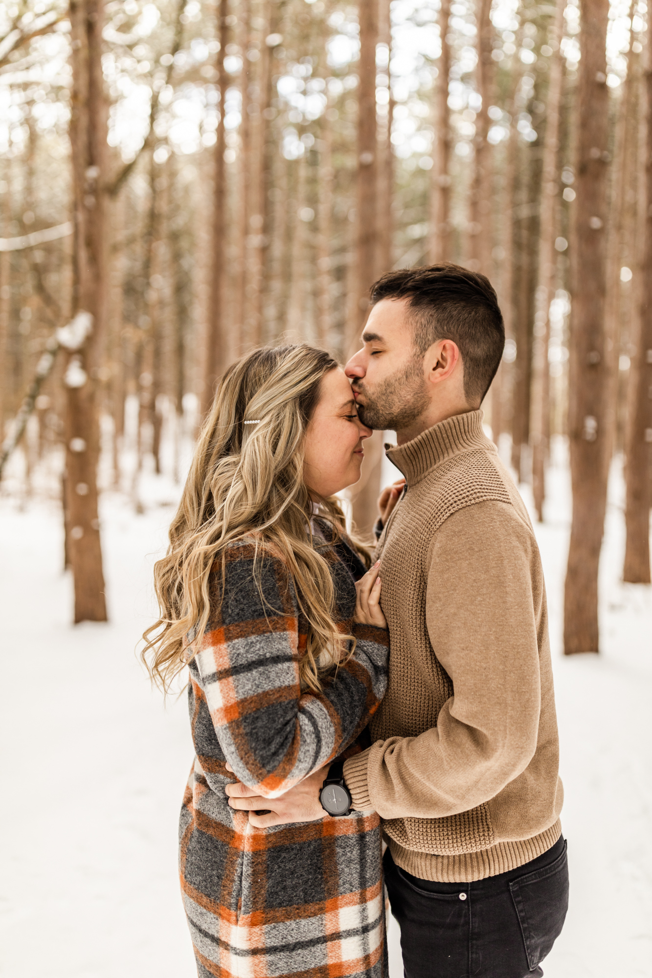 snow winter engagement photos in Michigan forest