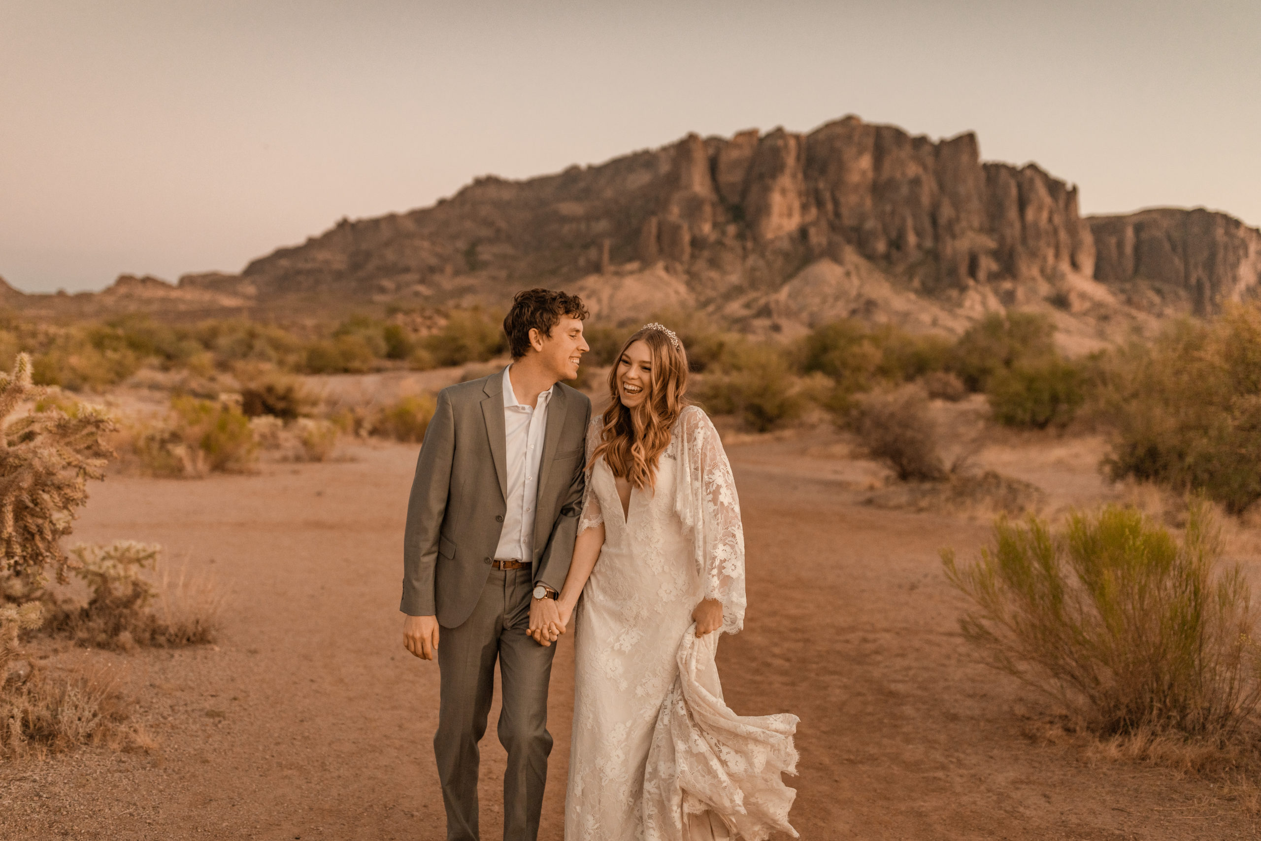 bride and groom holding hands in Arizona desert elopement