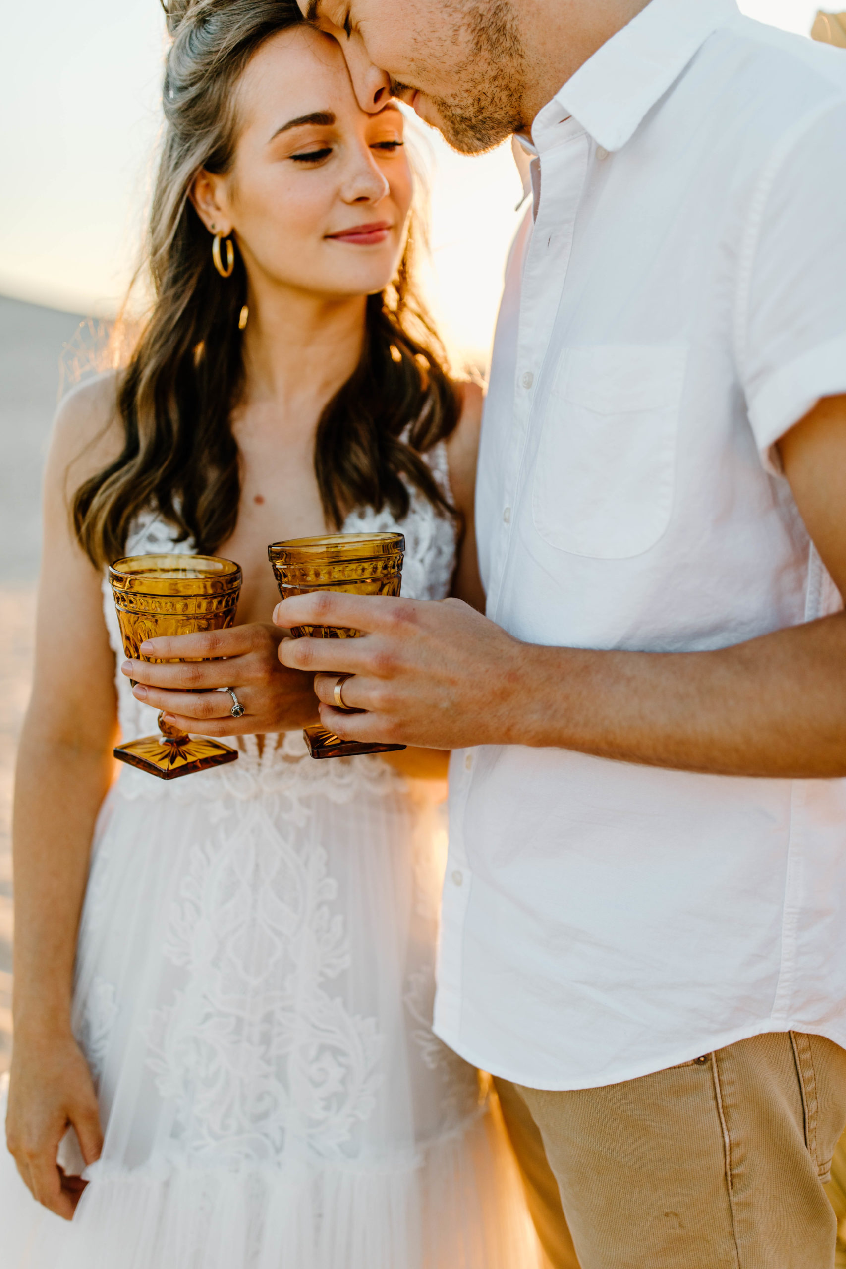 bride and groom holding boho cups at Michigan Wedding