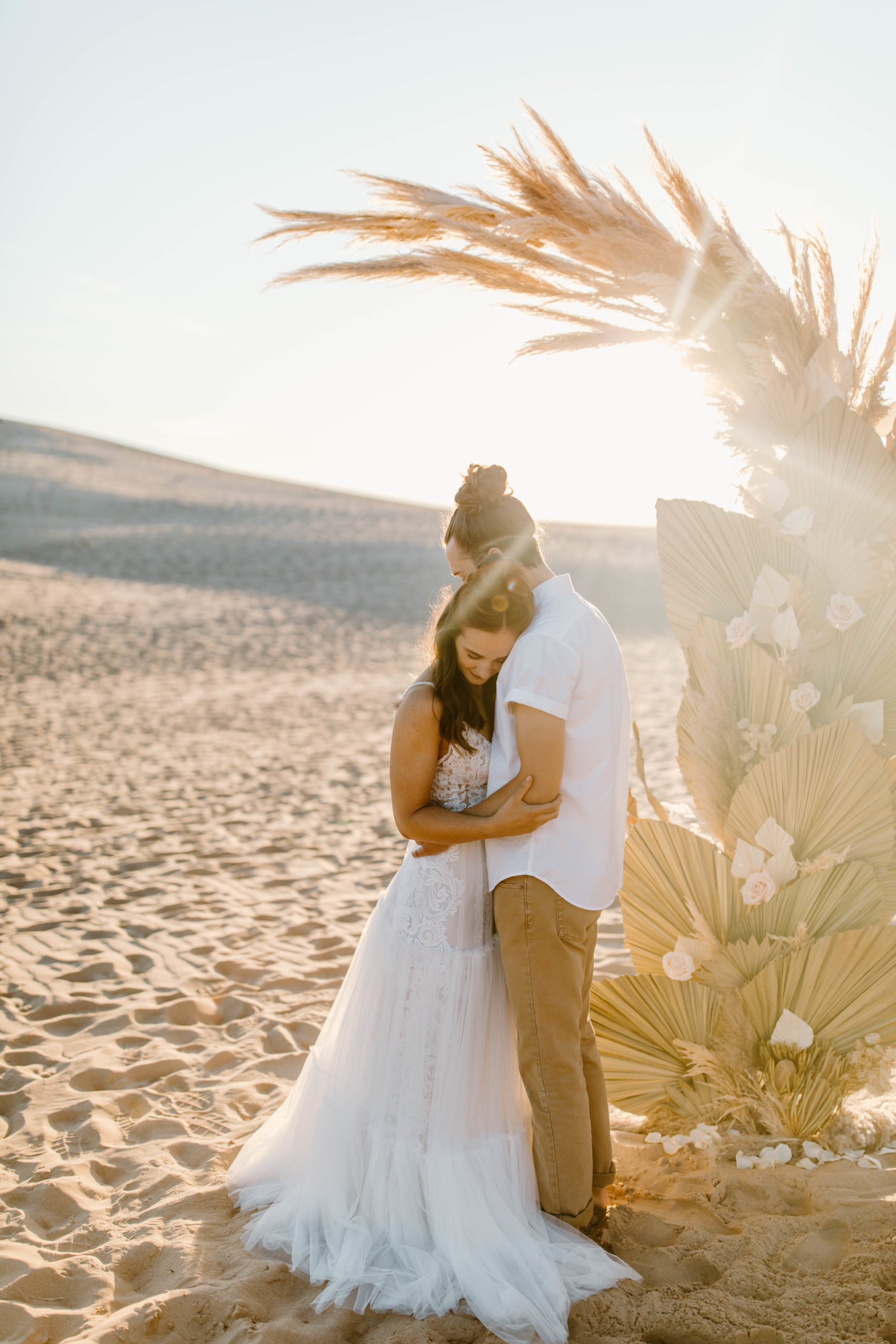 Boho Sand Dune Elopement in front of Palms and Pampas Grass ceremony arch