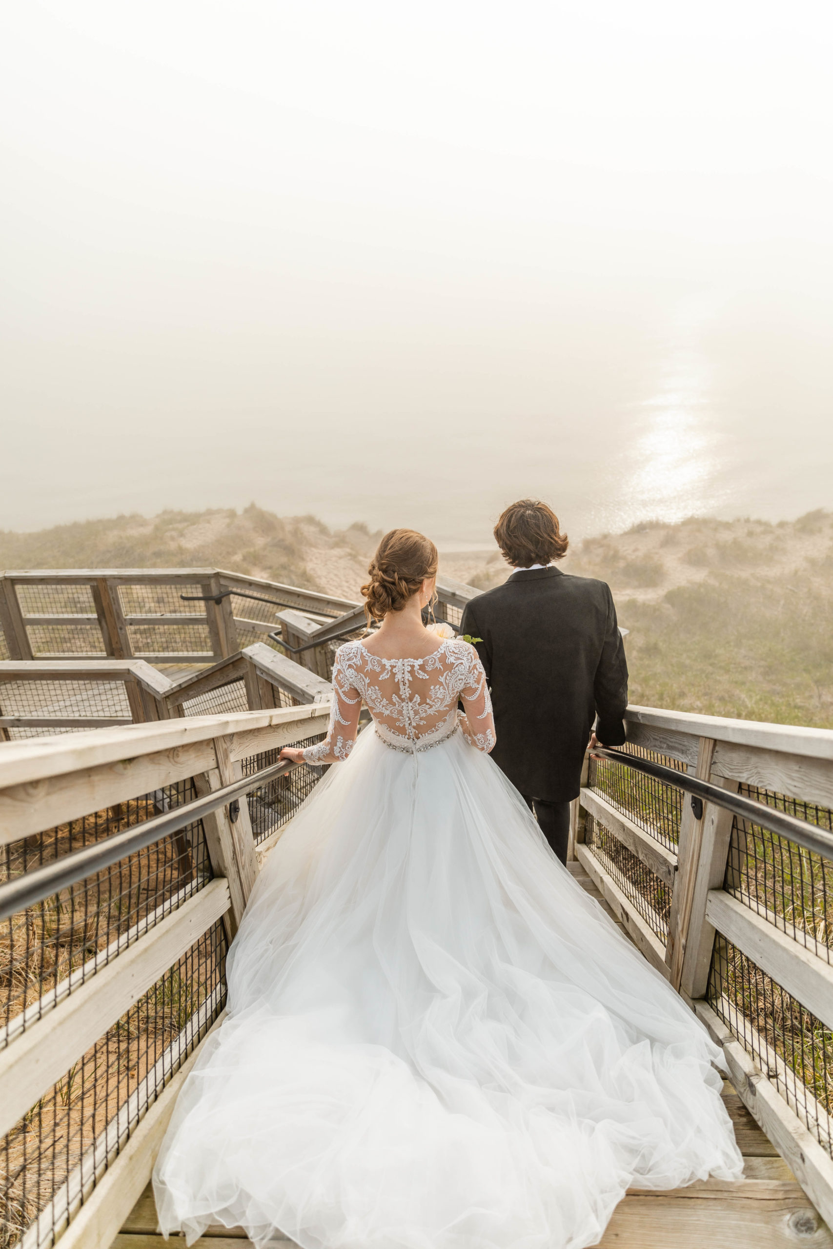 Michigan elopement wedding going down stairs through the dunes at the beach
