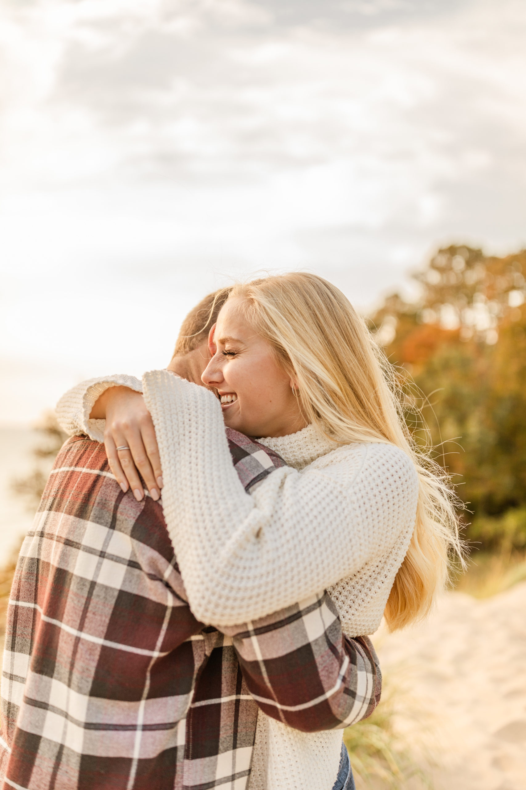 couple hugging and smiling on the beach engagement photos