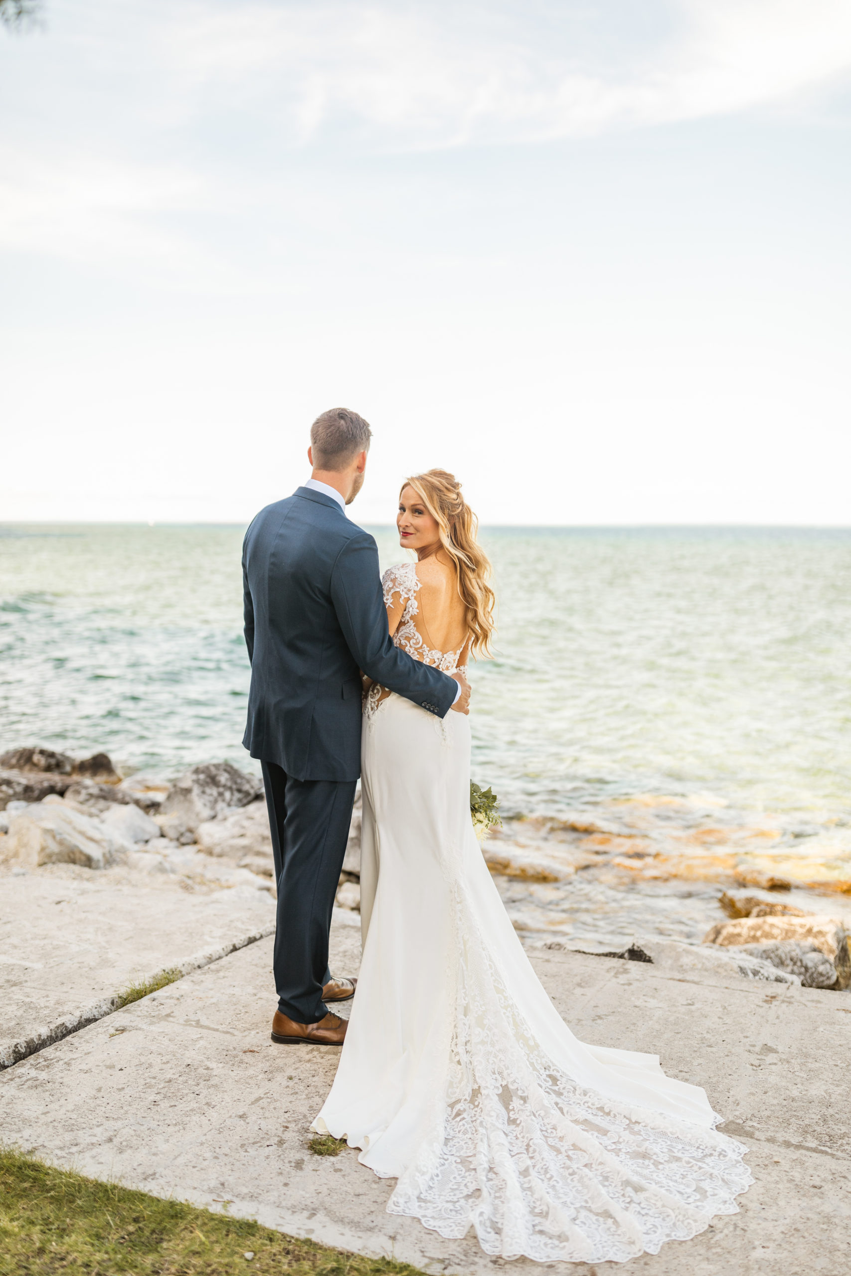 Bride and groom standing in front of Lake Michigan