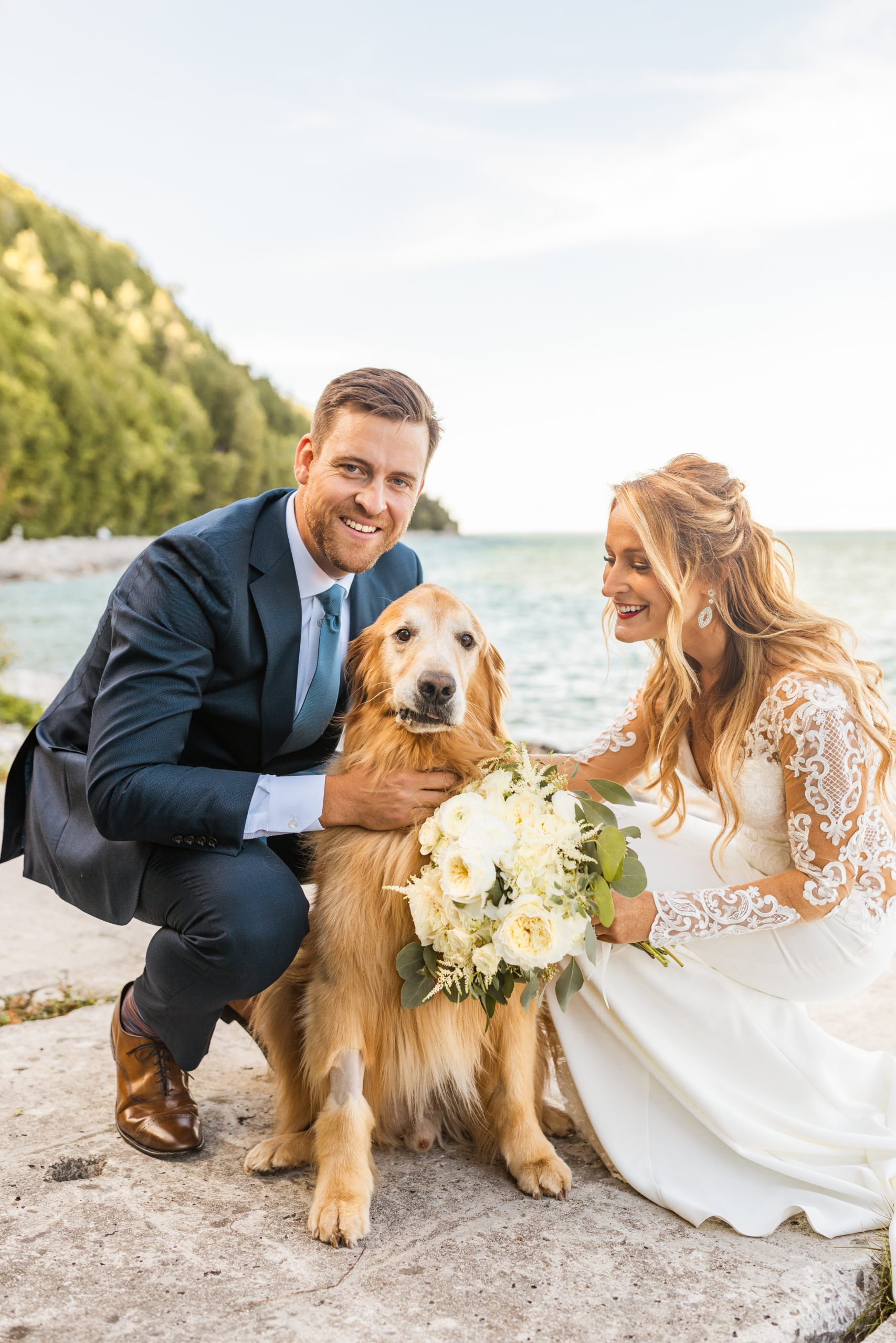 Bride and groom posing with golden retriever at Lake Michigan Mackinac Island wedding