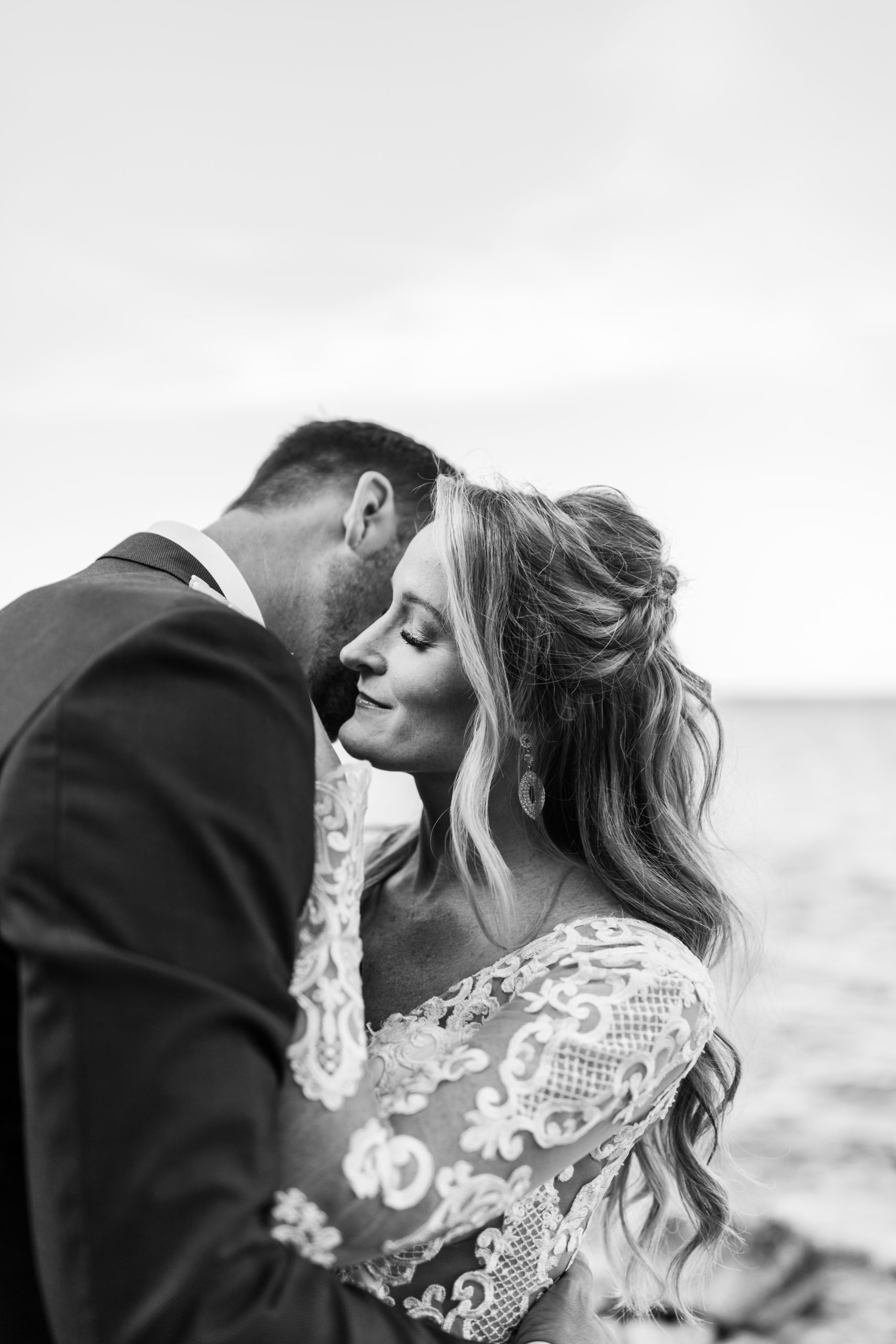 Bride and groom hugging in front of Lake Michigan 