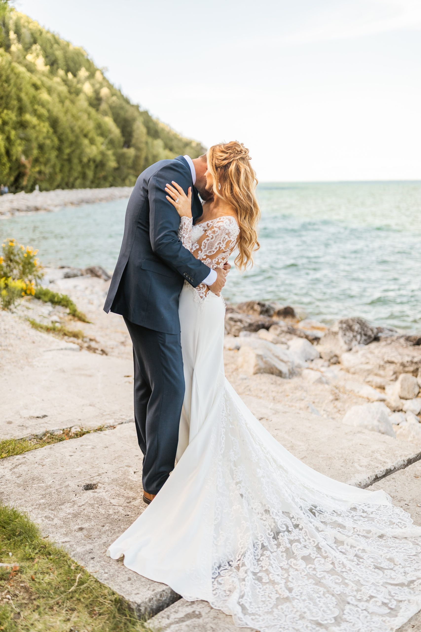Bride and groom hugging in front of Lake Michigan 