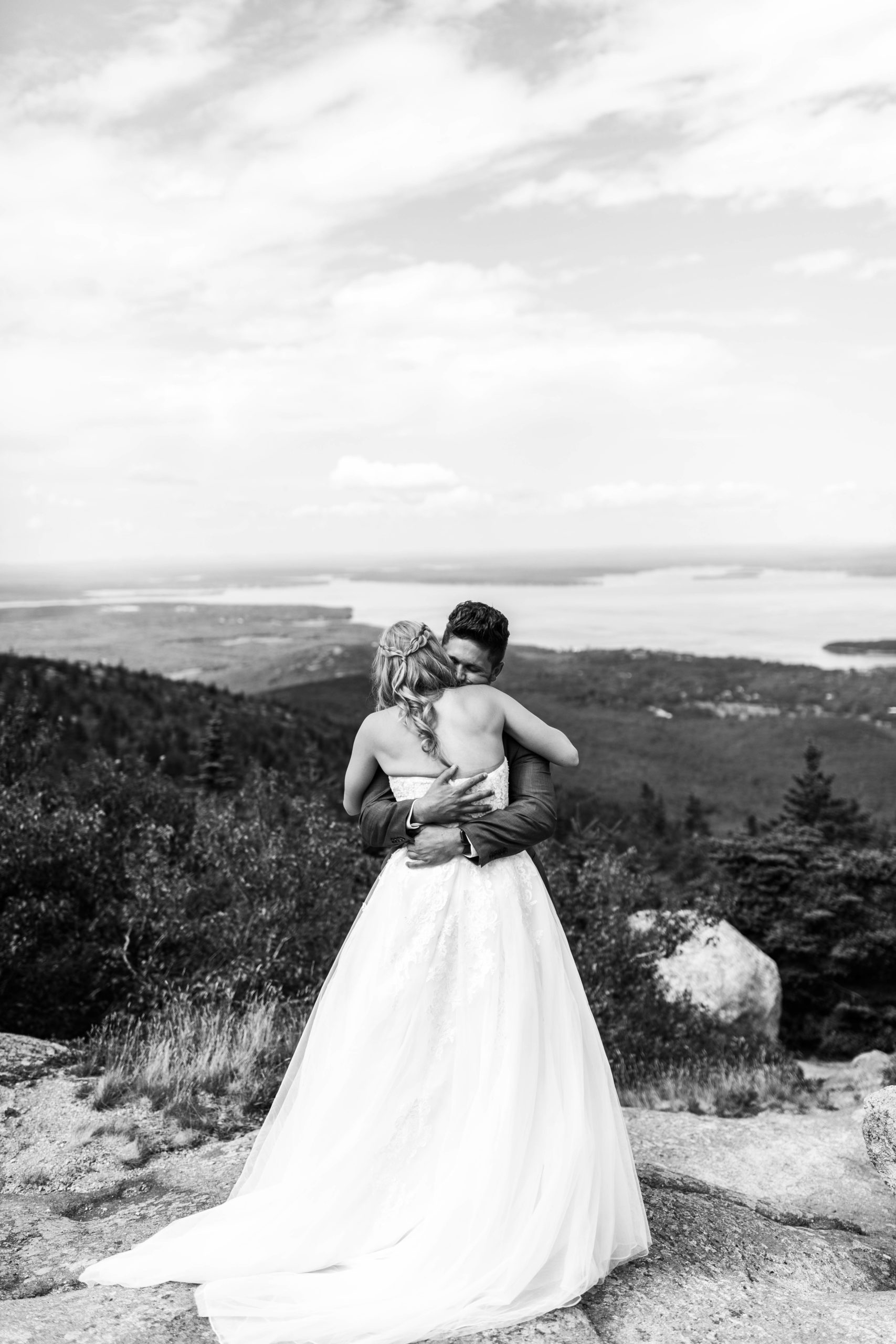 bride and groom hugging at at top of mountain at acadia national park elopement