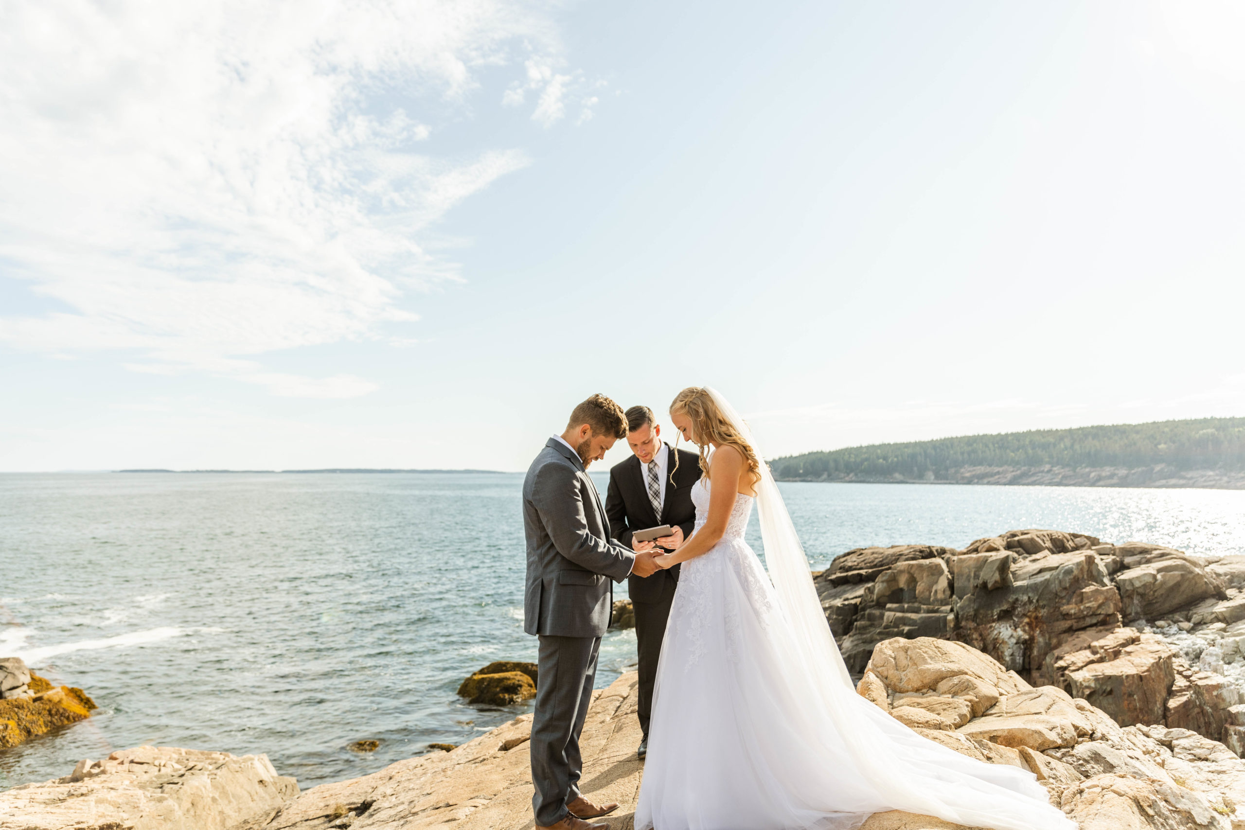 bride and groom standing in front of officiant at acadia national park elopement 