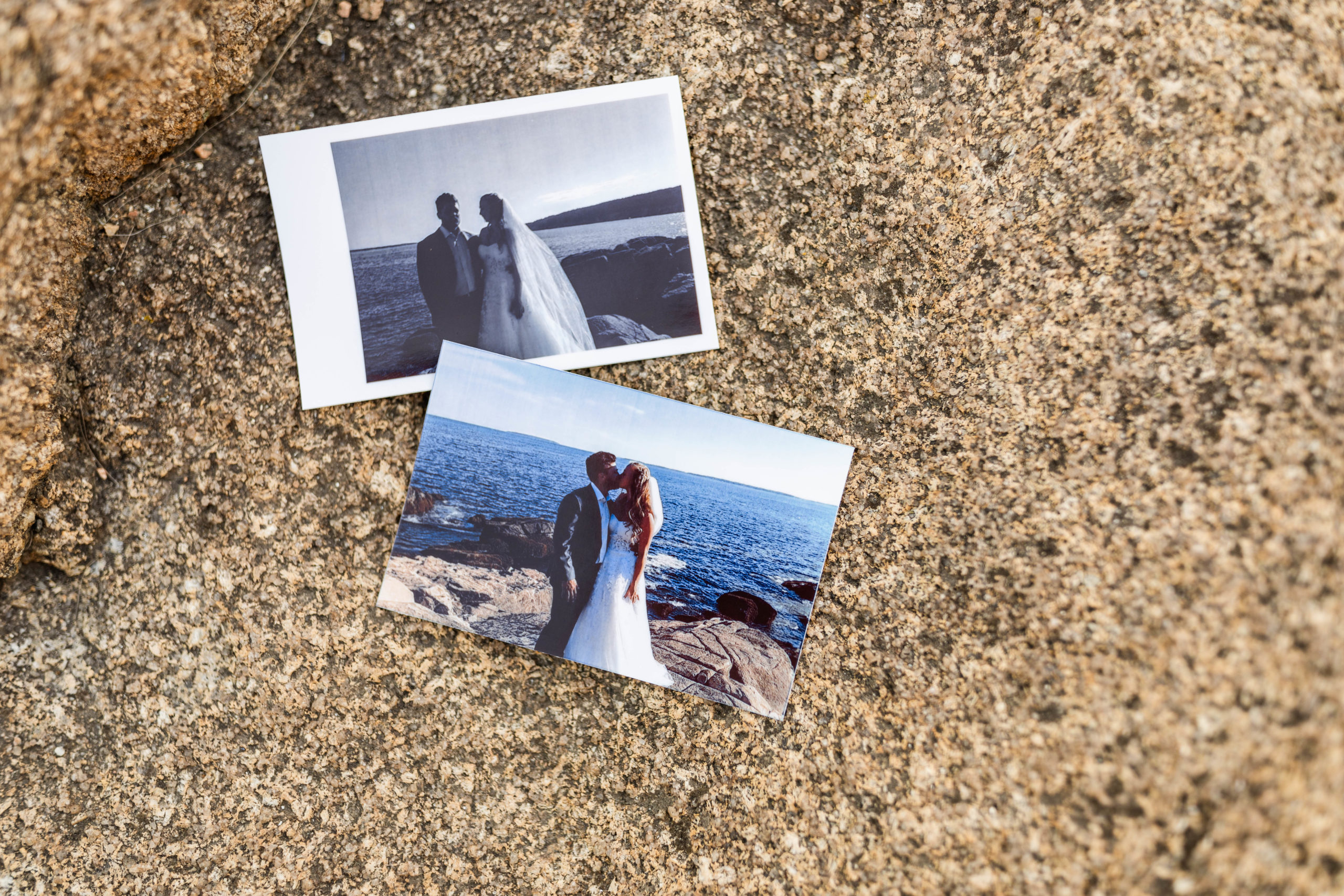 Polaroids sitting on rock of wedding photos