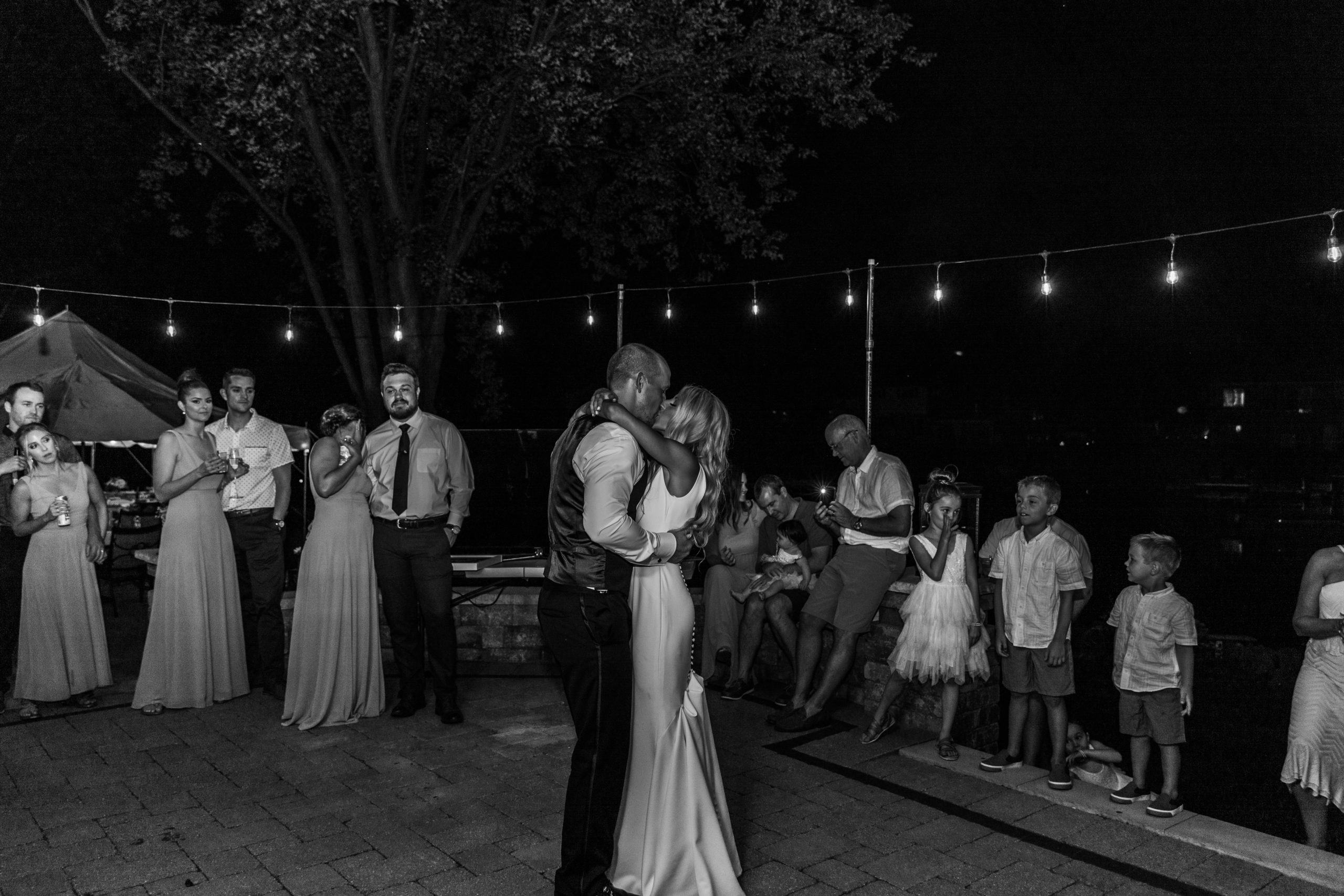 bride and groom dancing under lights at Michigan intimate wedding reception