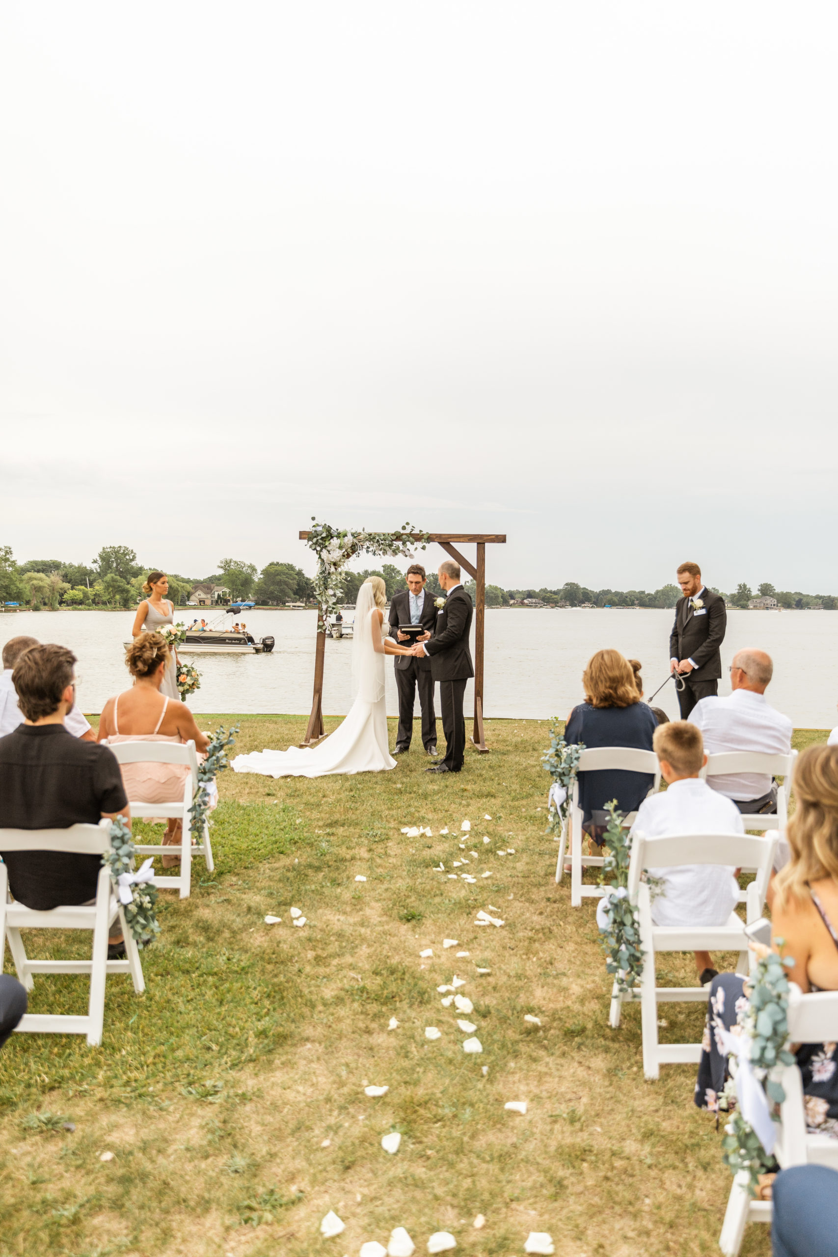 bride and groom exchanging vows at michigan lakefront wedding ceremony 