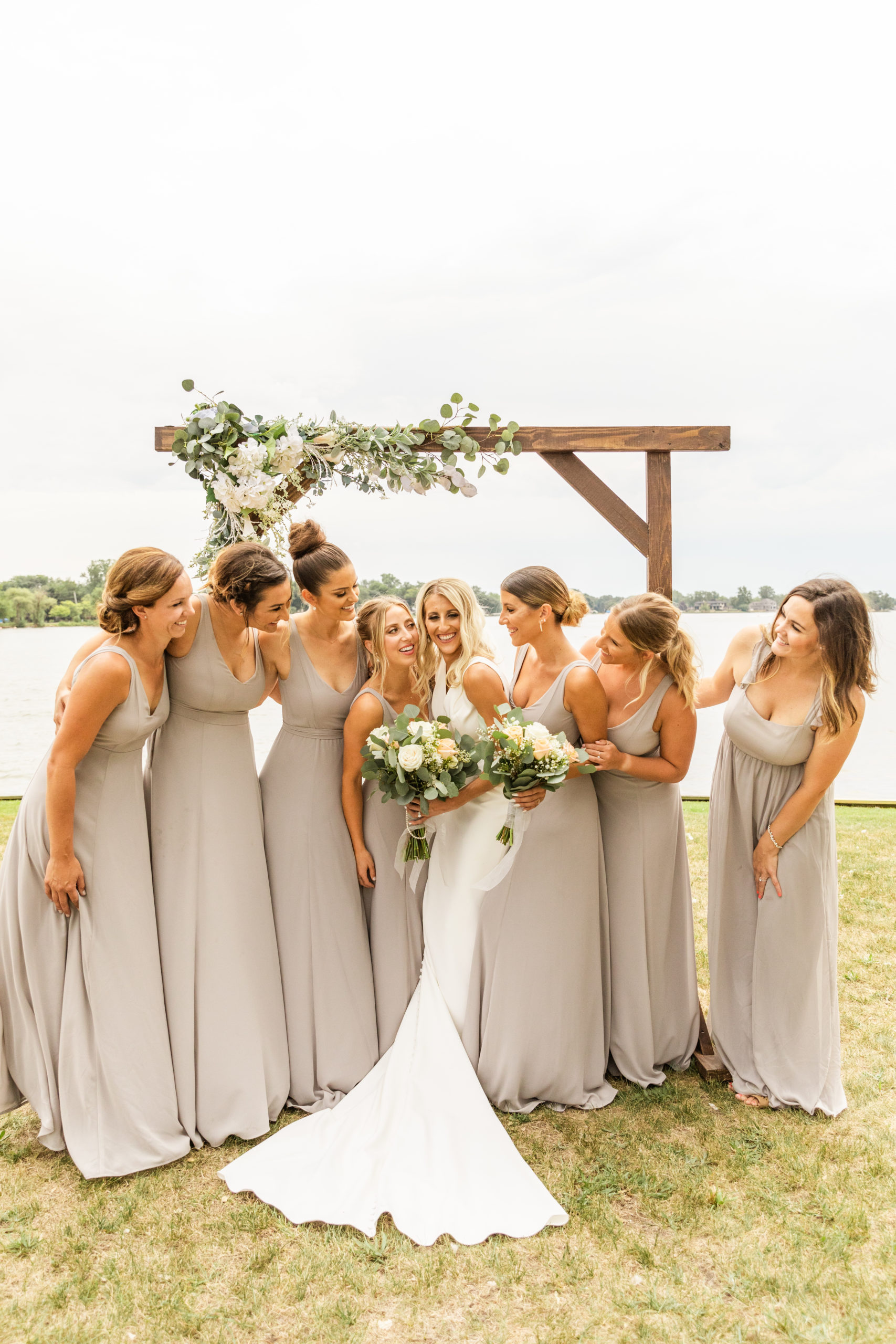 bride hugging and smiling with bridesmaids