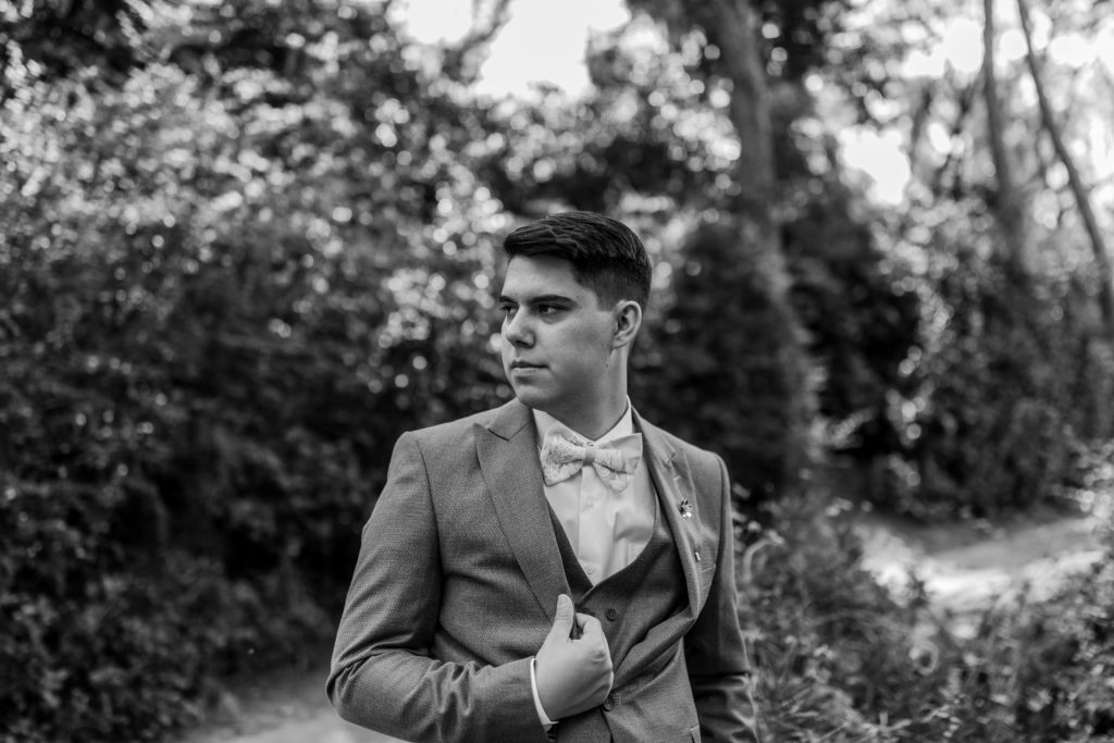 black and white photo of groom on wedding day