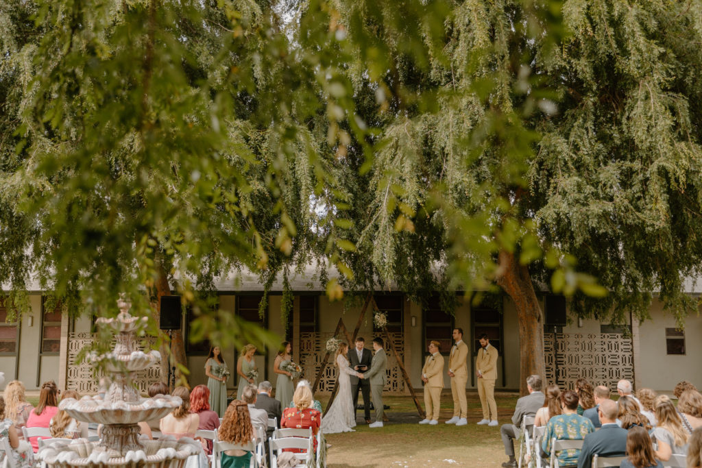 Outdoor courtyard wedding ceremony with willow trees in California