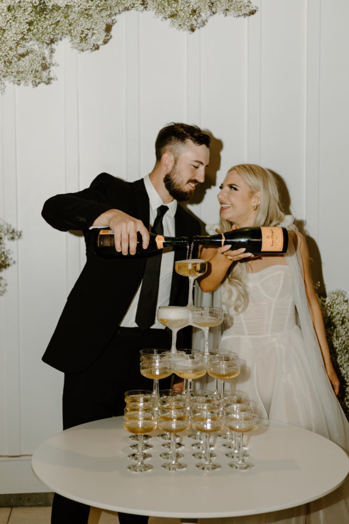 Champagne tower wedding photos bride groom flash photography