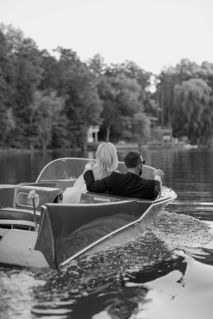 Bride and groom in a vintage boat on Michigan in Saugatuck