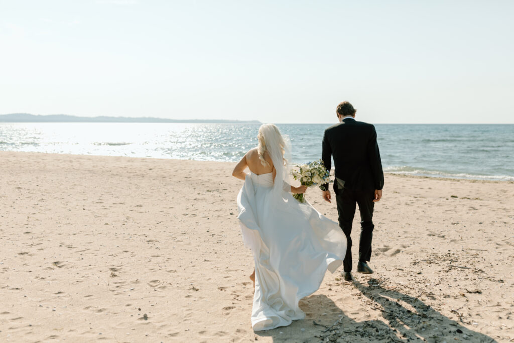 Bride and groom on beach in Leelanau Michigan